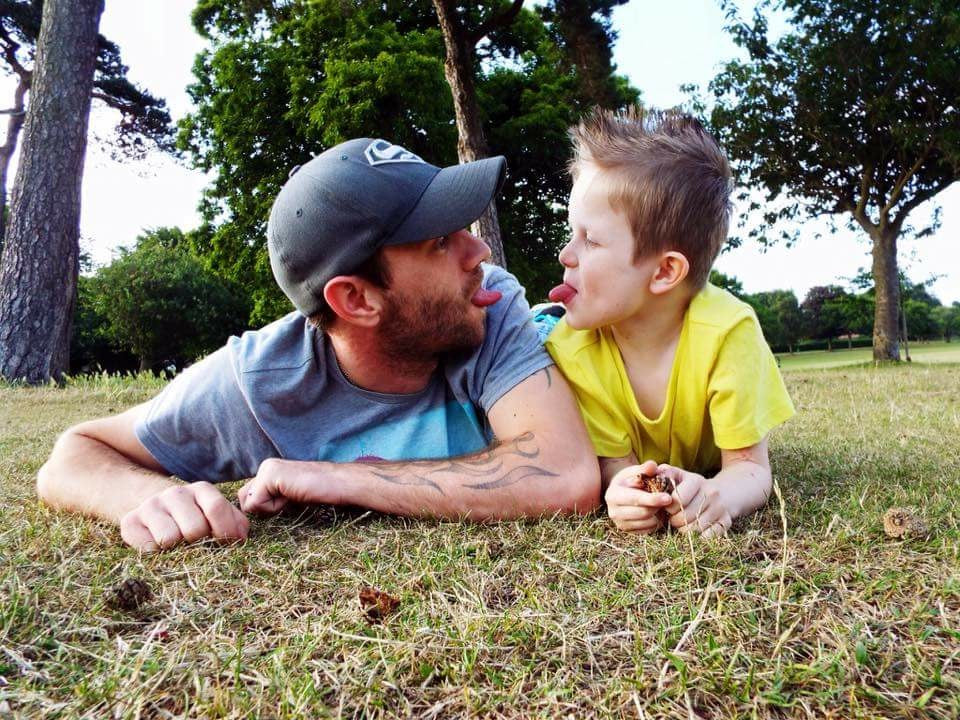 Father and son playing in a field